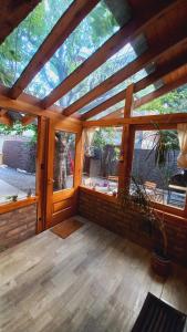 サン・マルティン・デ・ロス・アンデスにあるLa casita de Maichuの大きな窓付きの広い木造の客室です。