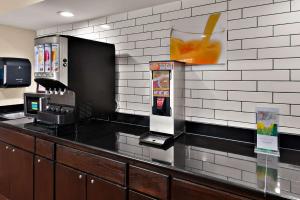 a drink dispenser with a drink in a drink at Quality Inn Memphis Northeast near I-40 in Memphis