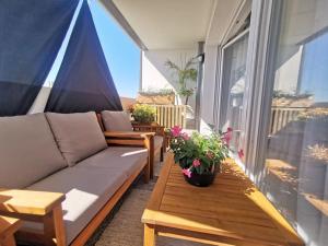 a living room with a couch and a table on a balcony at Chambre chez habitant proche Métro in Toulouse
