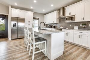 a kitchen with white cabinets and stainless steel appliances at Modern Sadieville Home with Yard and Gas Grill! in Corinth