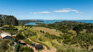 an aerial view of a farm with a view of the water at Awaawa - Rangi Yurt in Palm Beach
