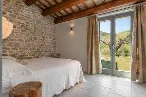 a bedroom with a bed and a large window at Panfilo Farmhouse in Cellino Attanasio