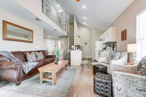 a living room with a brown leather couch and a table at Branson Condo on Golf Course, 4 Mi to Downtown in Branson