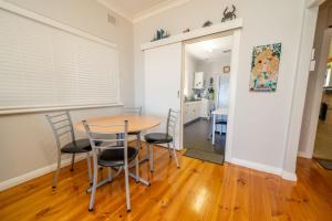 a kitchen and dining room with a table and chairs at Brighton Beachfront Sanctuary - Retro Coastal Charm in Brighton +15 photos