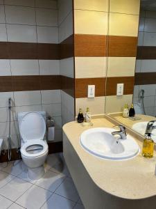 a bathroom with a toilet and a sink at Dubai Entire Serviced Room Unit Excellence in Dubai
