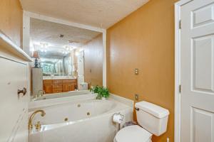 a bathroom with a tub and a toilet and a sink at Lakefront Leesburg Home with Private Dock and Ramp! in Centre +32 photos