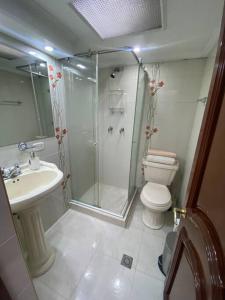 e bagno con doccia, servizi igienici e lavandino. di Hermosa casa con gran ubicación a Bogotá
