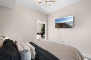 Un dormitorio con una cama y un cuadro en la pared. en Irvine Luxury & Modern Home, en Santa Ana