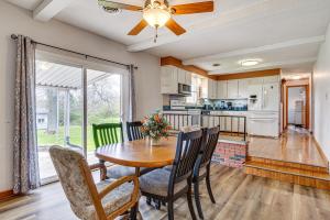 a kitchen and dining room with a table and chairs at Quaint Economy Retreat with Patio and Spacious Yard! 