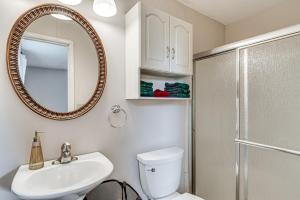 a bathroom with a toilet and a sink and a mirror at Quaint Economy Retreat with Patio and Spacious Yard! 