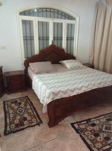 a bedroom with a large bed with a window at villa les oliviers in Port El Kantaoui