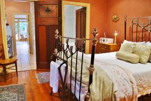 A bed or beds in a room at North Adelaide Heritage Cottages & Apartments