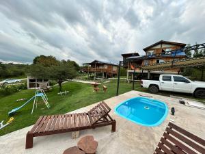 a large backyard with a pool and a house at Amaneceres de San Isidro in José de la Quintana