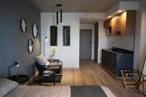 a bedroom with a bed and a table and a kitchen at UNDICI By OWN Republica de la Boca in Buenos Aires