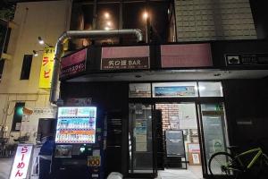 a gas station on a city street at night at e-house第二ビル in Tokyo