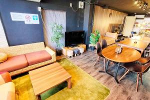a living room with a couch and a table at e-house第二ビル in Tokyo