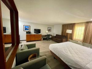 a hotel room with a bed and a television at Portside Inn & suites in San Pedro