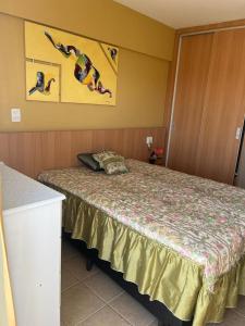 a hotel room with a bed with people jumping at Apartamento Mobiliado com Área de Lazer in Caldas Novas