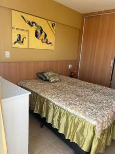 a hotel room with a bed with people jumping at Apartamento Mobiliado com Área de Lazer in Caldas Novas +4 photos