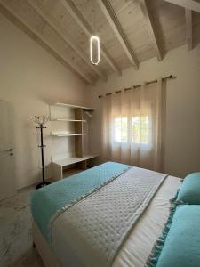 a bedroom with a large bed and a window at Villa Marianna-Nina Holidays in Paralia Sikias