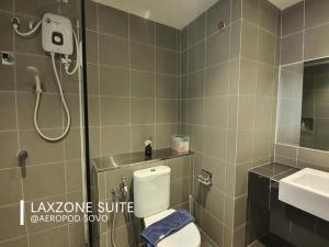 a bathroom with a shower and a toilet and a sink at Aeropod Studio - Laxzone in Kota Kinabalu