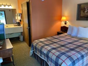 una habitación de hotel con una cama y un lavabo en Country Mountain Inn, en Eureka Springs