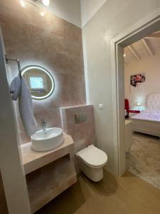 a bathroom with a sink and a toilet and a bed at Villa Marianna-Nina Holidays in Paralia Sikias