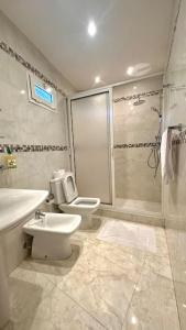 a bathroom with a toilet and a sink and a shower at Grand Appartement Agdal Centre I Suite & Billard in Rabat