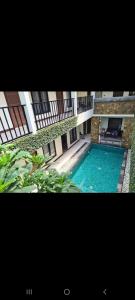 a large swimming pool in the middle of a building at Umah Bagus in Sanur