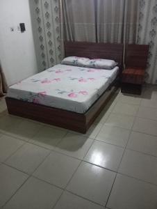 a bed sitting in a room with at Crale and Busino in Port Harcourt