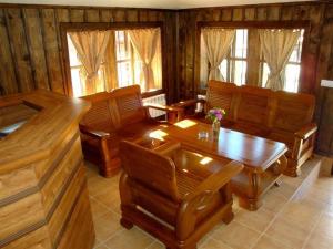 a living room filled with furniture and a wooden table at Voevodski Eco Complex in Katunishte
