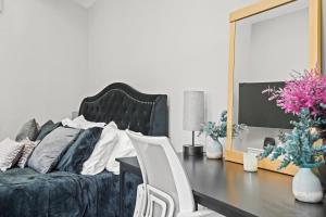 a bedroom with a bed and a table and a mirror at New Modern Cozy Guest House, Parking, Pet Friendly in Mar Vista! in Los Angeles