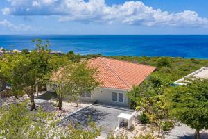 an aerial view of a house with the ocean in the background at NEW Amazing Villa with Sea Views-Walk to Beach-8 guests-Private Pool in Willibrordus