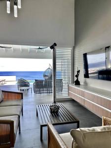 a living room with a view of the ocean at NEW Amazing Villa with Sea Views-Walk to Beach-8 guests-Private Pool in Willibrordus