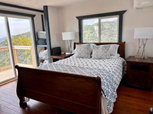 a bedroom with a bed and two windows at Mystic Mountain Retreat in Miramonte