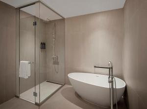 a bathroom with a bath tub and a shower at The Westin Resort Guam in Tumon