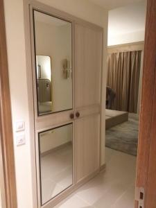 a large wooden cabinet with a mirror in a room at Address marassi resort in El Alamein