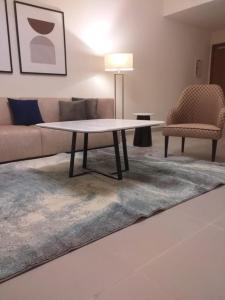 Address marassi resort في العلمين: غرفة معيشة مع طاولة قهوة وأريكة