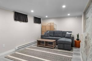 a living room with a couch and a coffee table at Chic House with King Bed, Walk To Dining and Starbucks in Dieppe