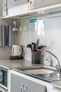 a kitchen with a sink and a counter top at Emu Bay Holiday Homes in Emu Bay