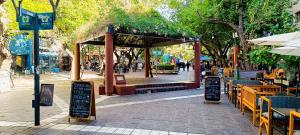 an outdoor cafe with tables and chairs and a pavilion at Departamento en peatonal, centro de Mendoza!! in Mendoza