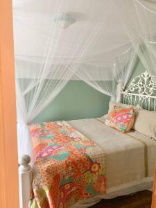 a small bedroom with a bed with a canopy at Countryside Haven in Pickens