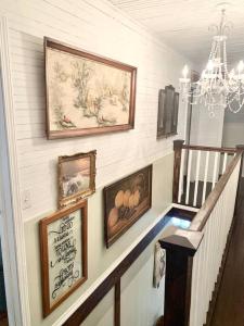 a staircase with pictures on the wall and a chandelier at Countryside Haven in Pickens