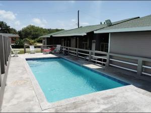 a swimming pool in front of a house at Corrales House in Tela