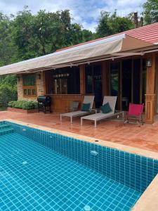 a house with a swimming pool in front of it at Bella Vista Khao yai in Ban Muak Lek Nai +60 photos