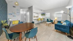 a dining room and living room with a table and chairs at SPI Beach Condo - Just a block away to Paradise in South Padre Island