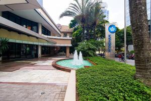 a fountain in the middle of a sidewalk in front of a building at Vossa Bossa Berrini in Sao Paulo