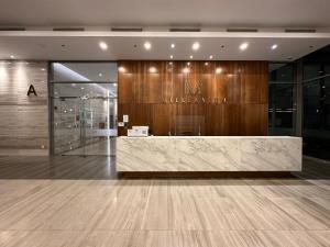 a lobby with a reception desk in a building at Olala SaiGon Apartment - Millennium Tower in Ho Chi Minh City