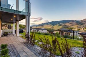 a glass house with a view of the mountains at Luxury Golf Stay w/Hot Tub in Kelowna