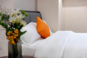 Ένα ή περισσότερα κρεβάτια σε δωμάτιο στο East Maple Hotel Apartment - Guangzhou Financial City Sanxi Metro Station